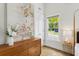 Bright bedroom with a four-poster bed, hardwood floors, a dresser, and a view of the well-manicured exterior at 22 Sheppard St, Charleston, SC 29403