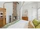 Bedroom with a four-poster bed, brick fireplace, beautiful hardwood floors, and built-in cabinets at 22 Sheppard St, Charleston, SC 29403