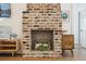 Living room showcasing a brick fireplace with white tulips inside, flanked by mid-century modern furniture at 22 Sheppard St, Charleston, SC 29403