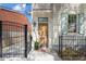 Inviting front entrance with a solid wood door, black iron fence, and a well-manicured potted plant at 22 Sheppard St, Charleston, SC 29403