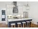 Bright kitchen with stainless steel fridge, marble island, and modern light fixtures at 22 Sheppard St, Charleston, SC 29403