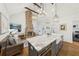 Open floor plan featuring marble kitchen island, brick fireplace, living area, and modern lighting at 22 Sheppard St, Charleston, SC 29403