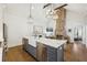 Open floor plan featuring kitchen with marble island, modern appliances, living area, and modern fireplace at 22 Sheppard St, Charleston, SC 29403