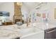 Bright kitchen featuring marble countertops, modern faucet, white farmhouse sink, and dining area at 22 Sheppard St, Charleston, SC 29403