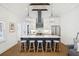 Bright open kitchen featuring a marble island with bar stools and pendant lights above at 22 Sheppard St, Charleston, SC 29403