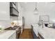 Open floor plan with marble kitchen island, stainless steel appliances, and living space in the background at 22 Sheppard St, Charleston, SC 29403