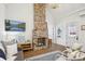 Cozy living room featuring a brick fireplace, modern lighting, and hardwood flooring at 22 Sheppard St, Charleston, SC 29403