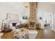 Inviting living room features a brick fireplace, couch, chairs, rug and access to another room at 22 Sheppard St, Charleston, SC 29403