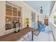 Inviting porch features a dining table and seating, along with rocking chairs for relaxation at 22 Sheppard St, Charleston, SC 29403