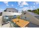 Inviting rooftop deck boasts comfortable Adirondack chairs and a wooden table with seating for four at 22 Sheppard St, Charleston, SC 29403