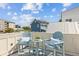 Relaxing rooftop deck featuring Adirondack chairs with cushions and a small side table at 22 Sheppard St, Charleston, SC 29403