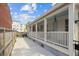 Inviting side porch featuring white railings, a sky blue ceiling, and a private outdoor space at 22 Sheppard St, Charleston, SC 29403