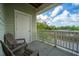 Cozy balcony features two chairs, a door to the building and a view of the treeline in the distance at 2244 Ashley Crossing Drive Dr # 621, Charleston, SC 29414