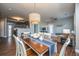 Open concept dining area with wood table, white chairs, modern light fixture, and hardwood floors at 2244 Ashley Crossing Drive Dr # 621, Charleston, SC 29414