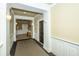Hallway with neutral colors, carpeting, and trim, and a dark wood entry door to the home at 2244 Ashley Crossing Drive Dr # 621, Charleston, SC 29414