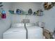 Functional laundry room featuring a washer and dryer, overhead storage shelves and white walls at 2244 Ashley Crossing Drive Dr # 621, Charleston, SC 29414