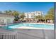 Community pool with clear water, pergola, pool house, and nearby condominium buildings at 2244 Ashley Crossing Drive Dr # 621, Charleston, SC 29414