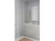 Elegant bathroom vanity with marble countertop, gold fixtures, and paneled walls at 2407 Atlantic Ave, Sullivans Island, SC 29482