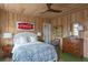 Cozy bedroom featuring wood paneled walls, vintage Coca-Cola sign and ceiling fan at 2407 Atlantic Ave, Sullivans Island, SC 29482