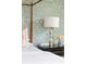 Detailed bedroom scene with four-poster bed, floral wallpaper, a lamp, and bedside table at 2407 Atlantic Ave, Sullivans Island, SC 29482