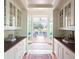 Butler's pantry boasts custom cabinetry and outdoor views at 2407 Atlantic Ave, Sullivans Island, SC 29482