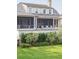 Picturesque home exterior featuring a screened porch, manicured lawn, and elegant architecture at 2407 Atlantic Ave, Sullivans Island, SC 29482