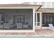 Expansive outdoor patio featuring screened-in seating, ceiling fans, and a nearby lounge chair by the pool at 2407 Atlantic Ave, Sullivans Island, SC 29482