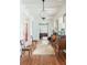 Beautifully lit hallway showcasing dark wood floors, white walls, and decorative accents at 2407 Atlantic Ave, Sullivans Island, SC 29482