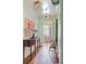Light-filled hallway with wood floors, modern lighting, and stylish console table with unique lamps at 2407 Atlantic Ave, Sullivans Island, SC 29482