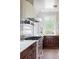 Well-appointed kitchen features stainless steel appliances, a view of the yard, and a tile backsplash at 2407 Atlantic Ave, Sullivans Island, SC 29482