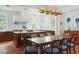 Spacious kitchen featuring a central island, wood cabinetry, modern appliances, and dining space at 2407 Atlantic Ave, Sullivans Island, SC 29482