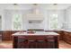 Charming kitchen with an island, stainless appliances, and decorative backsplash at 2407 Atlantic Ave, Sullivans Island, SC 29482