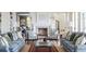 Bright and inviting living room with a fireplace, comfortable seating, and elegant decor at 2407 Atlantic Ave, Sullivans Island, SC 29482