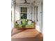 Cozy porch swing with plush cushions, offering a perfect spot to unwind and enjoy the peaceful surroundings at 2407 Atlantic Ave, Sullivans Island, SC 29482