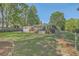 View of backyard with ample green space with a well maintained lawn and fence at 2645 Mona Ave, Charleston, SC 29414