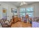 Eclectic bedroom featuring hardwood floors, ample light, and vintage furniture at 2645 Mona Ave, Charleston, SC 29414