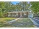 Inviting brick home featuring a well-kept front yard and a convenient attached garage at 2645 Mona Ave, Charleston, SC 29414