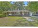 Charming brick home with a well-manicured lawn and mature trees providing ample shade at 2645 Mona Ave, Charleston, SC 29414