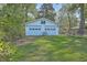 Exterior shot of a detached two-car garage with white siding and matching doors at 2645 Mona Ave, Charleston, SC 29414