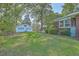Detached garage with white siding in a spacious, green backyard at 2645 Mona Ave, Charleston, SC 29414