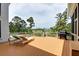 Spacious back deck featuring a grill, lounge chairs and overlooking a golf course and pool at 2732 Canebreak Ln, Mount Pleasant, SC 29466