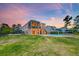 Backyard view of modern home with pool, well-manicured lawn and screened in porch at 2732 Canebreak Ln, Mount Pleasant, SC 29466