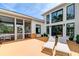 Spacious backyard patio with lounge chairs, screened-in porch, and modern exterior design at 2732 Canebreak Ln, Mount Pleasant, SC 29466