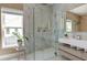 Bathroom featuring a glass enclosed shower, double sink vanity and stone tiling at 2732 Canebreak Ln, Mount Pleasant, SC 29466