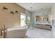 Well-lit bathroom featuring a soaking tub, a glass-enclosed shower, and a double sink vanity at 2732 Canebreak Ln, Mount Pleasant, SC 29466