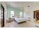 Bedroom with patterned wall, windows, modern light fixture, bed, and chair at 2732 Canebreak Ln, Mount Pleasant, SC 29466