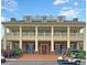 Attractive clubhouse with multiple stories, columns, and a golf cart parked outside at 2732 Canebreak Ln, Mount Pleasant, SC 29466