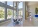 Modern dining area with large windows, stylish lighting, and view to a deck at 2732 Canebreak Ln, Mount Pleasant, SC 29466