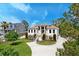 Beautiful exterior of home with circular driveway, lush landscaping and covered porch at 2732 Canebreak Ln, Mount Pleasant, SC 29466