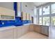 Well-lit kitchen featuring modern cabinets, stainless steel appliances, and a bright blue backsplash at 2732 Canebreak Ln, Mount Pleasant, SC 29466
